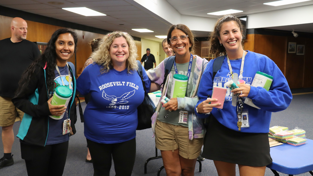 Group of 4 teachers pose for photo. 