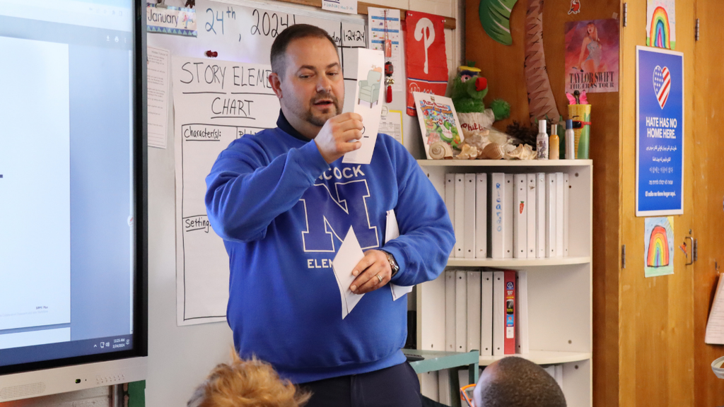Teacher holding up flash cards. 