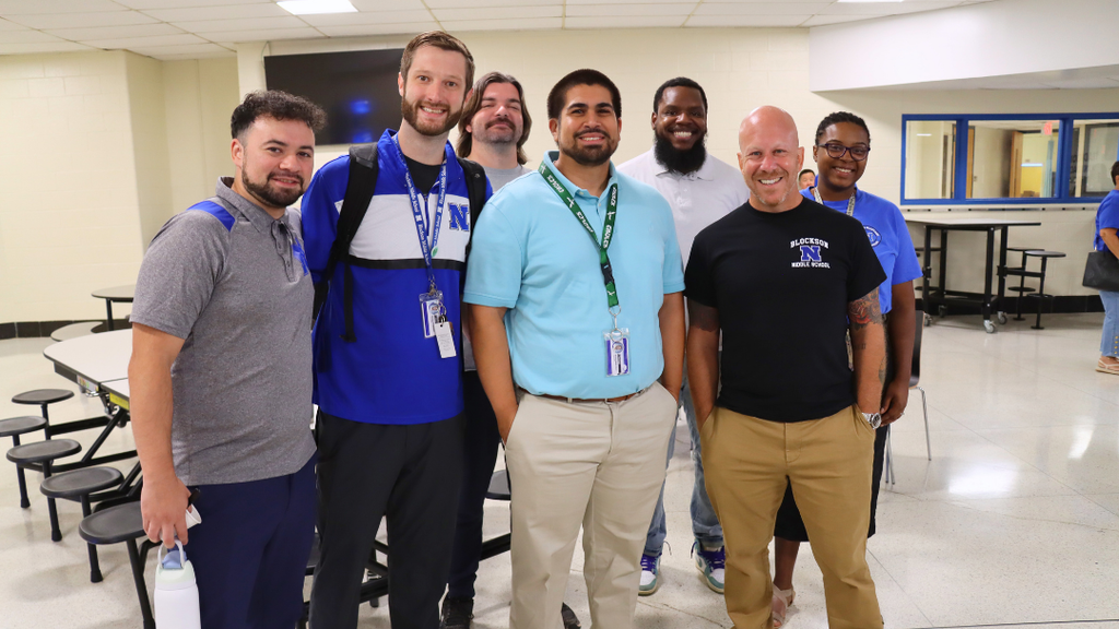 Group of 7 teachers pose for photo before attending the district opening ceremony for the school year. 