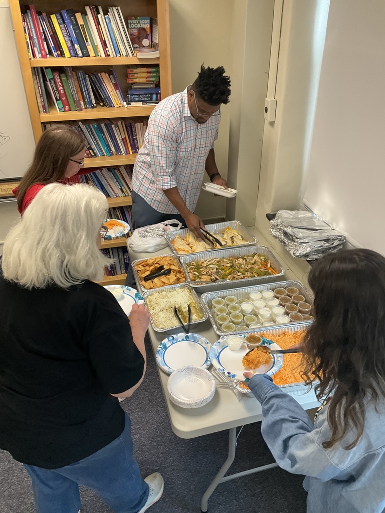 Teachers are scooping items from the lunch that was provided