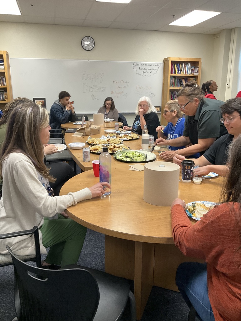 Staff is sitting together eating lunch.