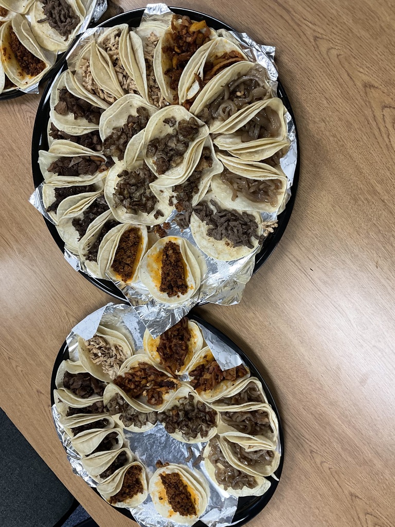 Two trays of tacos are photographed
