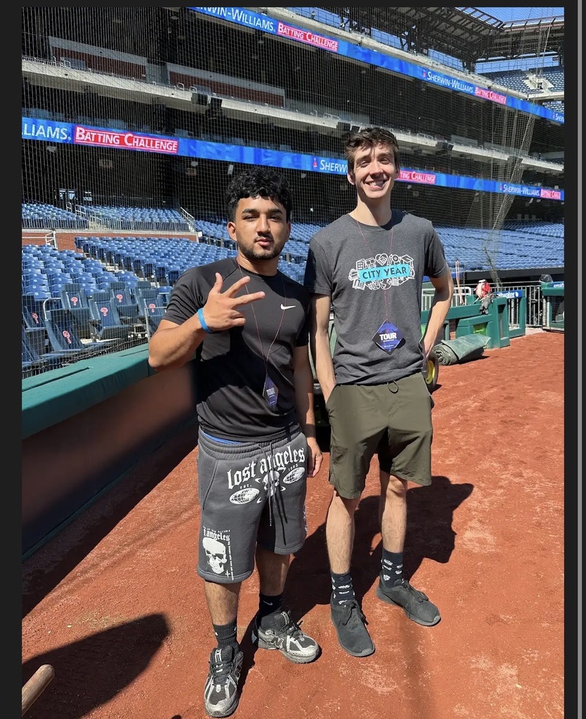 A student and city year member are posing on the Phillies field