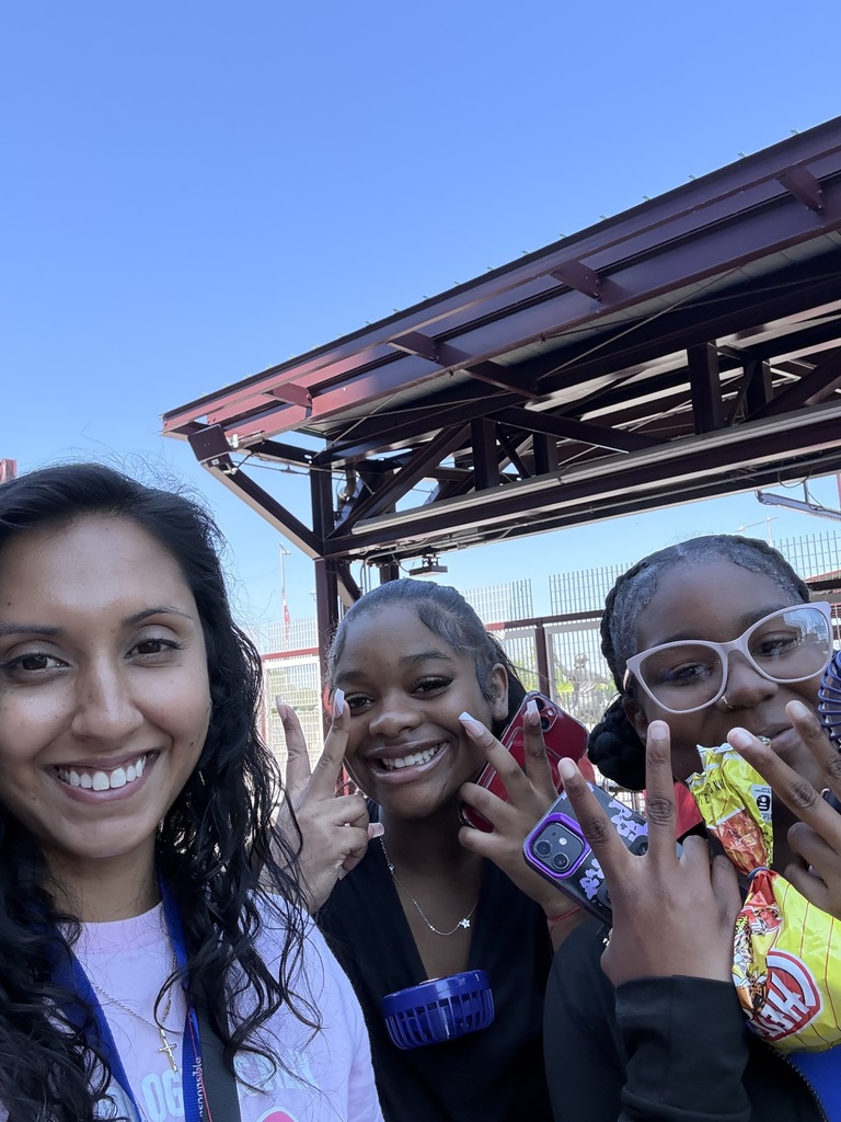 Two students and a teacher are posing for a selfie in the Phillies stadium