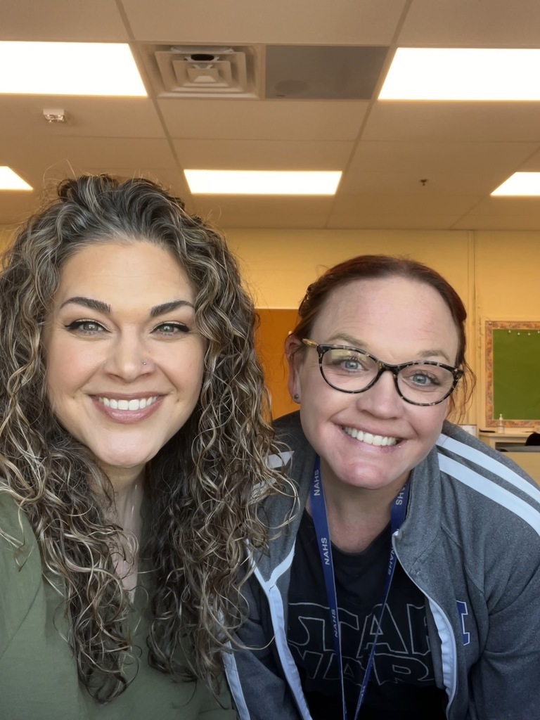 Two teachers are posing together