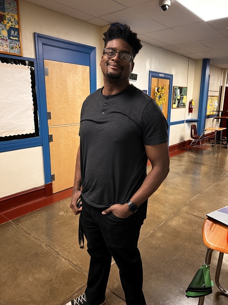 The math teacher is smiling in the hall