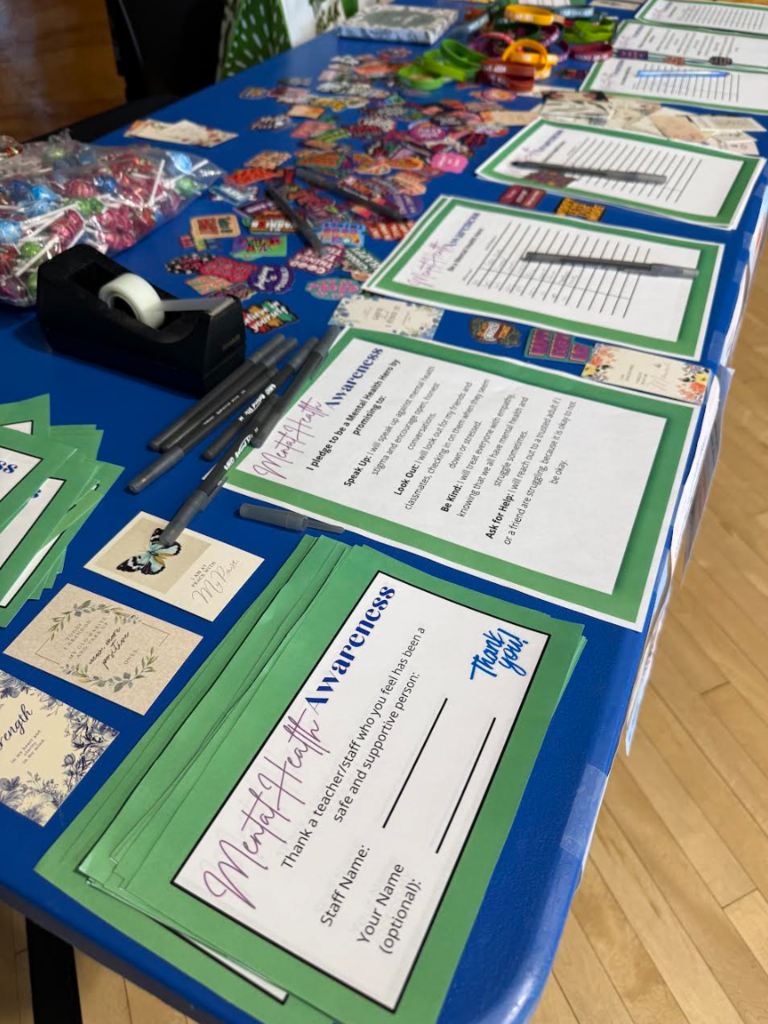Paper and stickers are on the table for students to use in the lunch room.