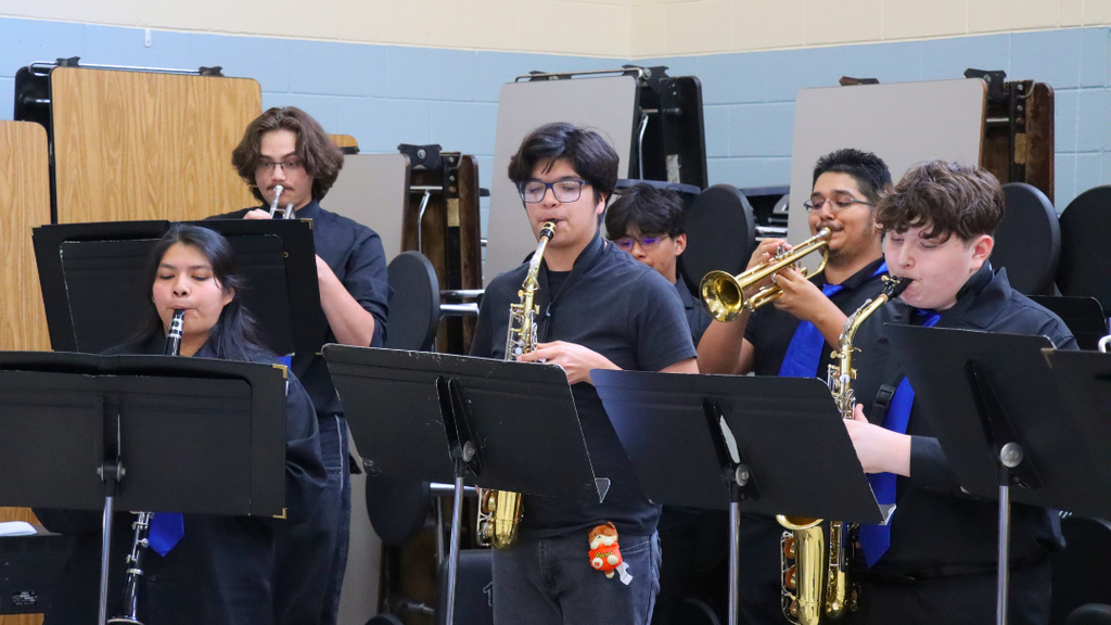 NAHS studnets playing brass and woodwind instruments at the retirement celebration.