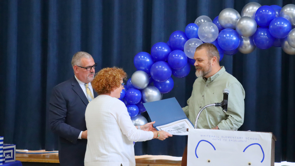 Retiree receiving certificate from supervisor.