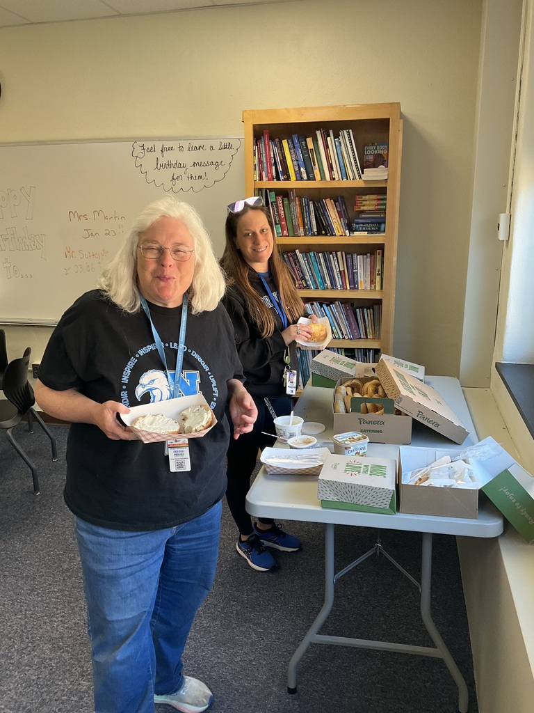 Two teachers are getting bagels in the conference room