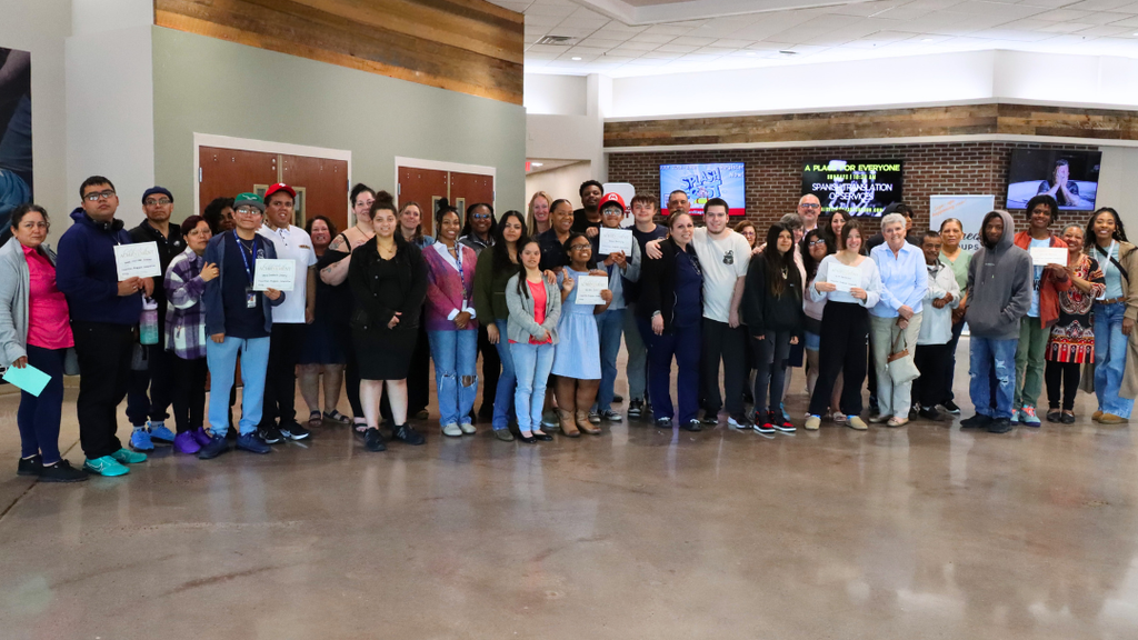 Students, staff, and families pose for large group photo during the luncheon.