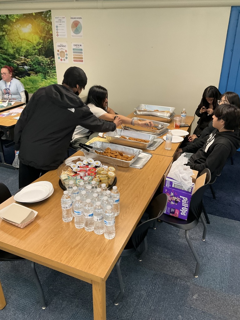 Students are surrounding some snacks