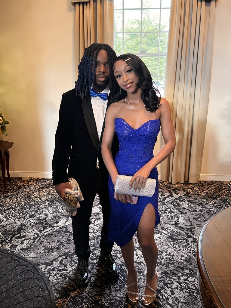 A couple is posing for prom inside