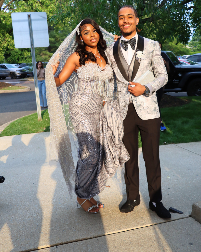 Two students pose for photo before going into prom venue.