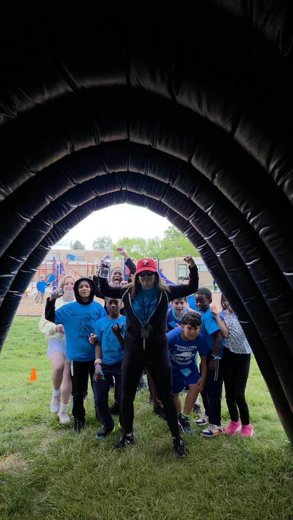 Students prepare to run through the tunnel.