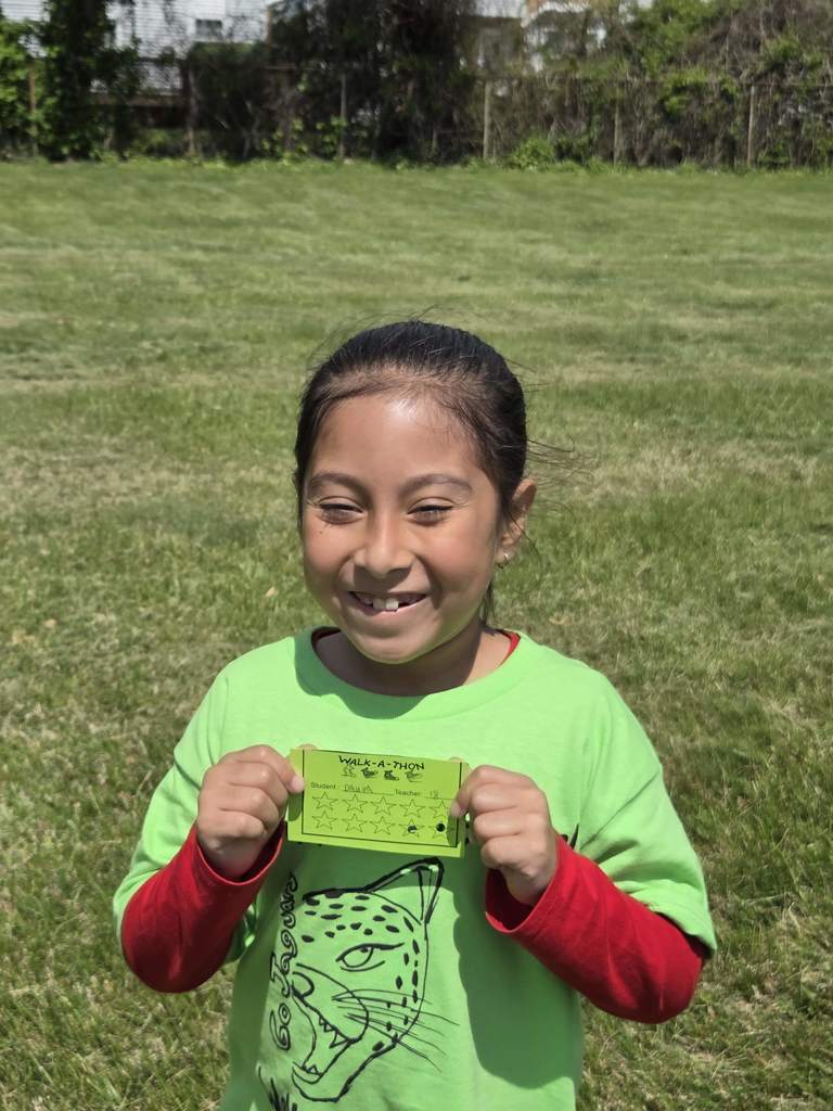 A student shows her lap card for the Walk-a-Thon.