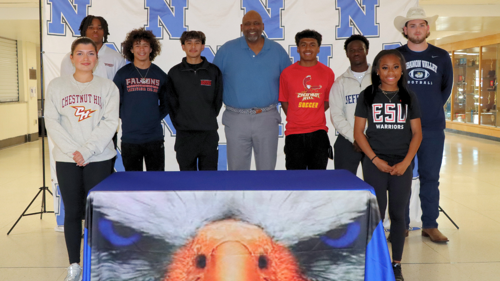 Eight seniors pose for photo with principal, Dr. McGriff.