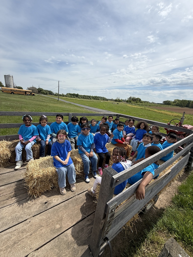 Kindergartners take a hay ride at the farm.