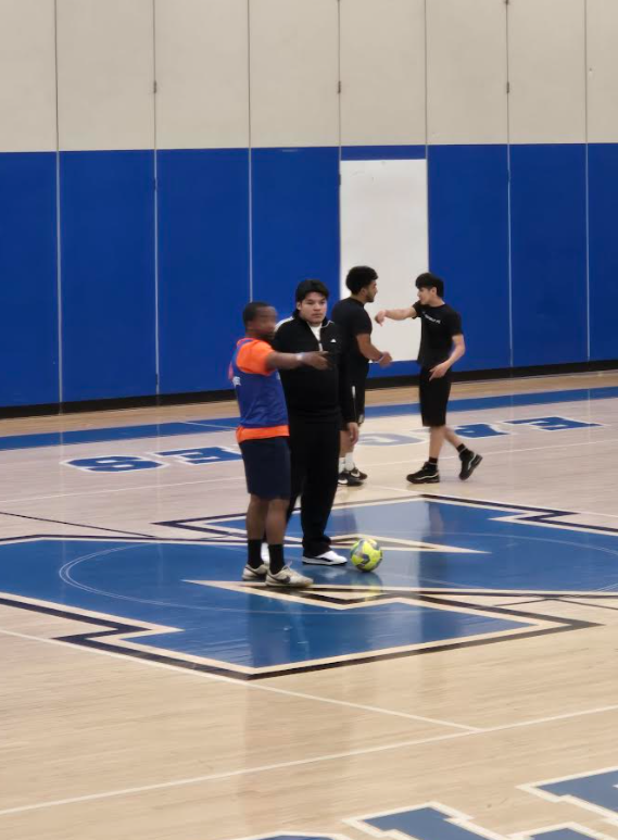Students are on the court playing soccer