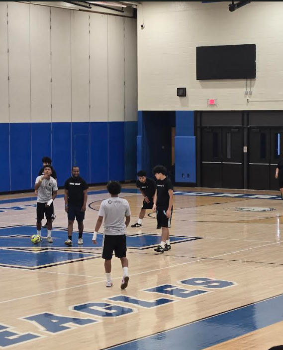 Students are on the court playing basketball