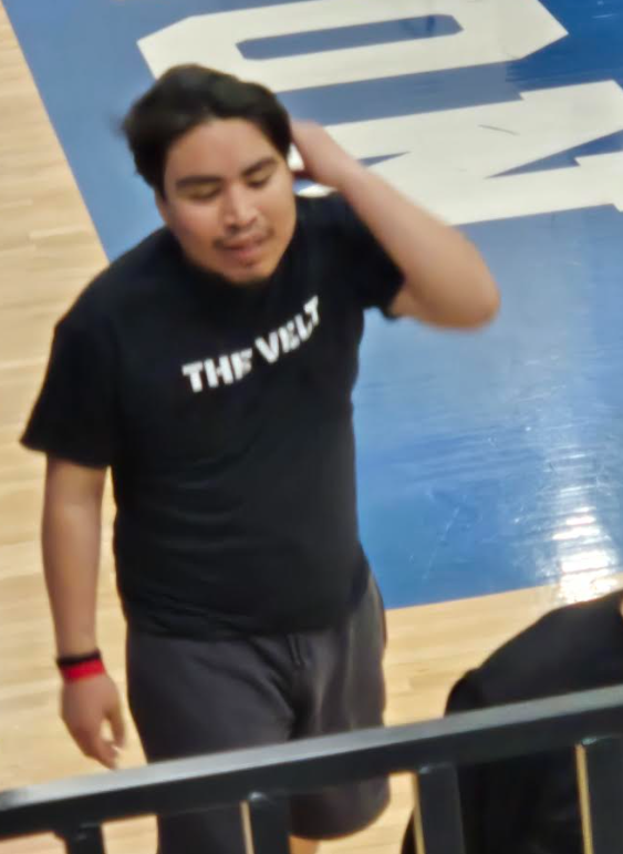 A student is walking off the court from playing soccer
