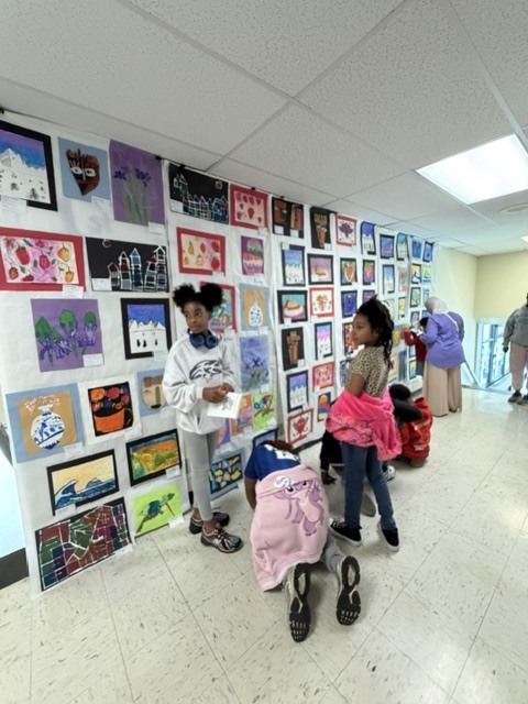 Students and families looking at art