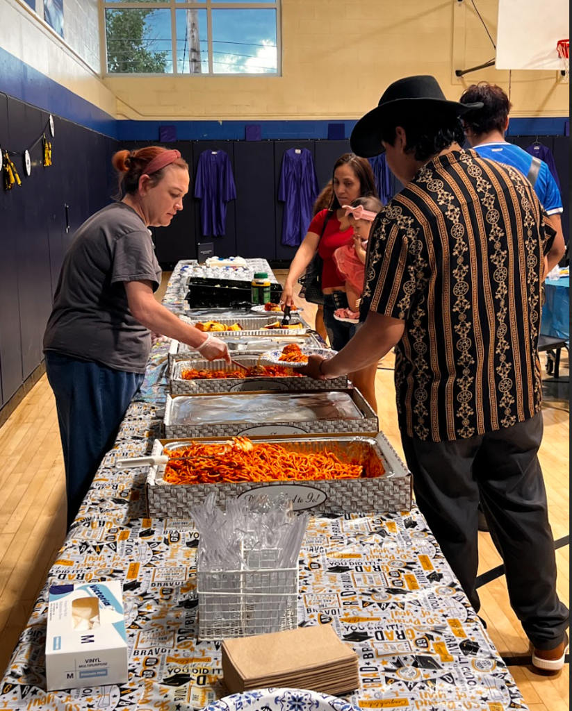 A teacher is serving a family dinner