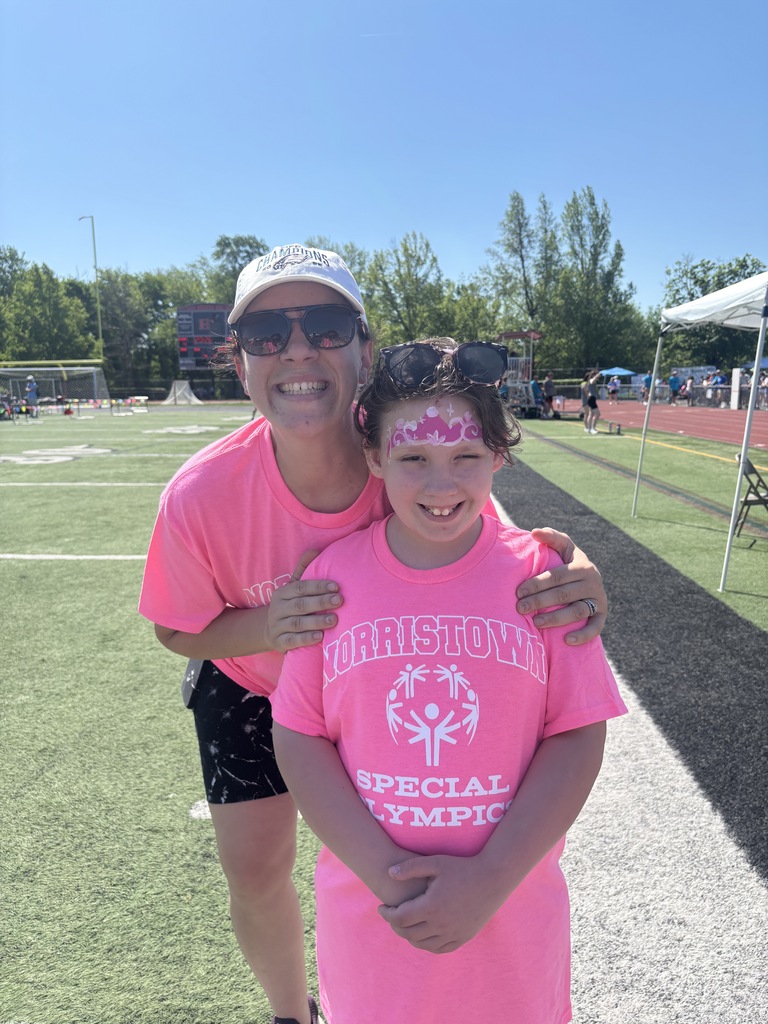 A teacher and student smiling at Special Olympics. 