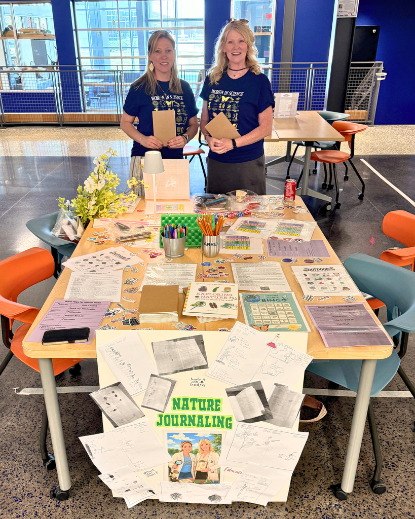 Two teachers at a table with nature journaling materials.