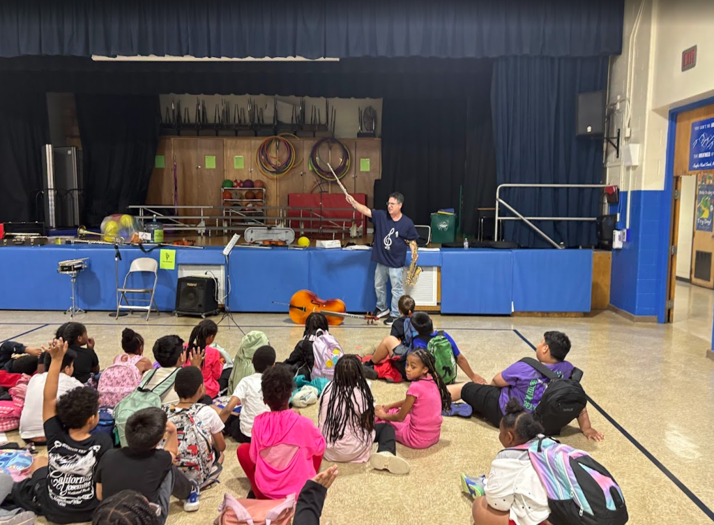 Students listening to a musical instrument. 