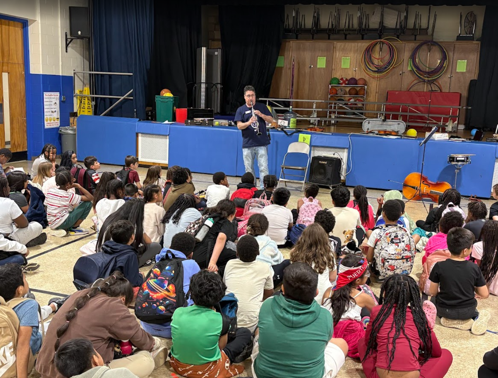 Students listening to a musical instrument. 
