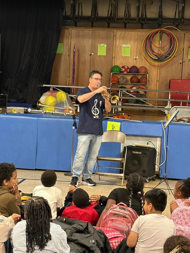Students listening to a musical instrument. 
