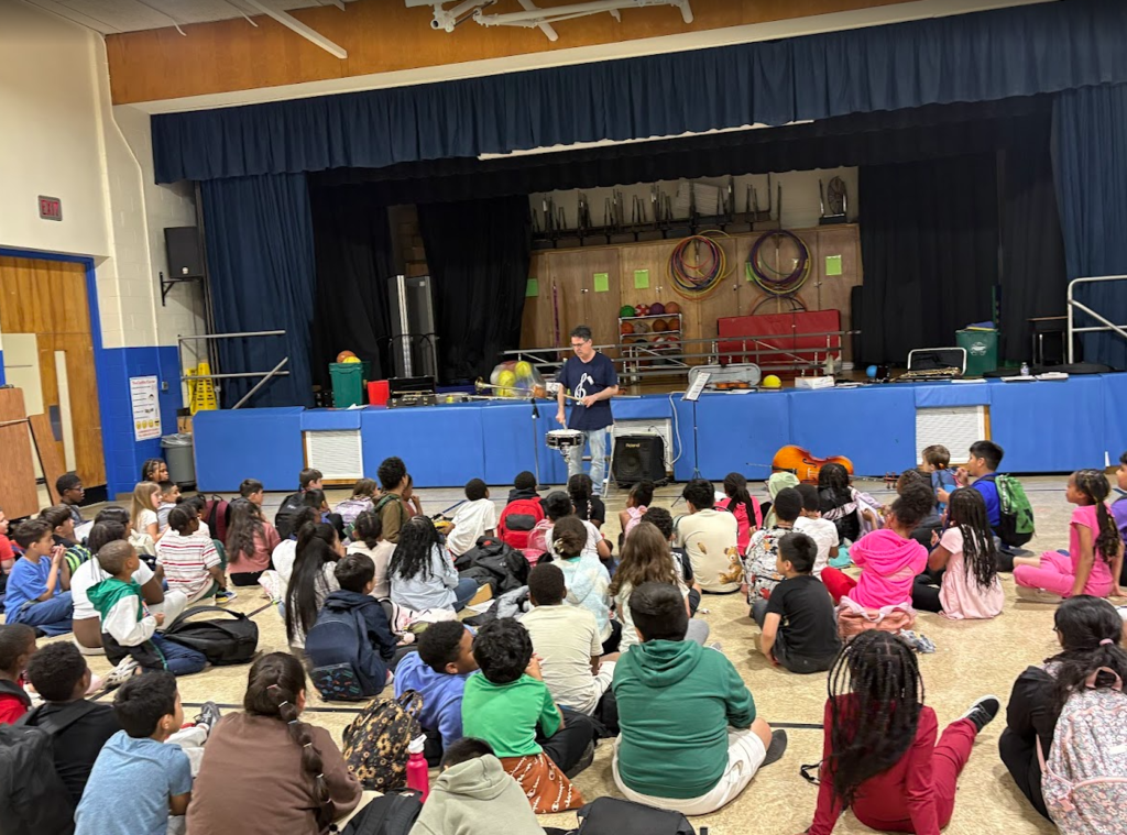 Students listening to a musical instrument. 