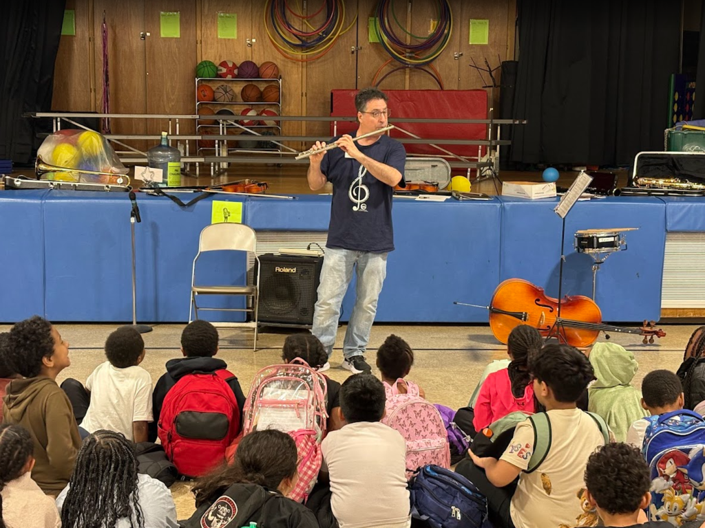 Students listening to a musical instrument. 