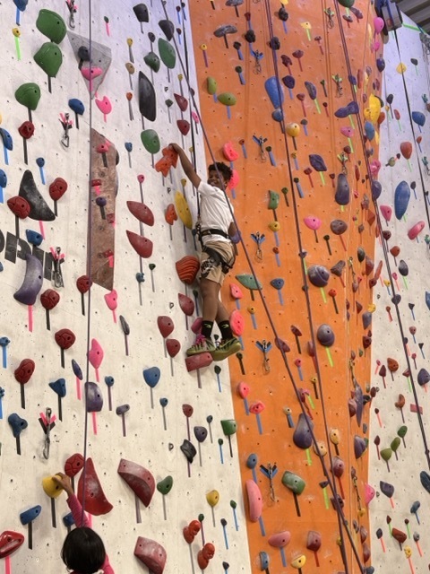 A fourth grader climbs a rock wall at the Philadelphia Rock Gym.