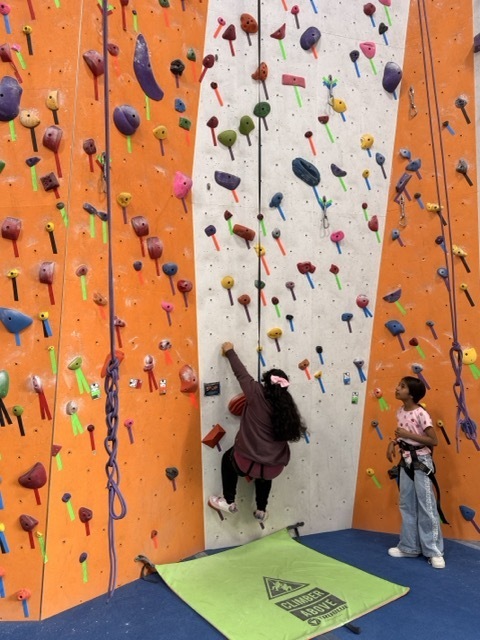 A fourth grader climbs a rock wall at the Philadelphia Rock Gym.