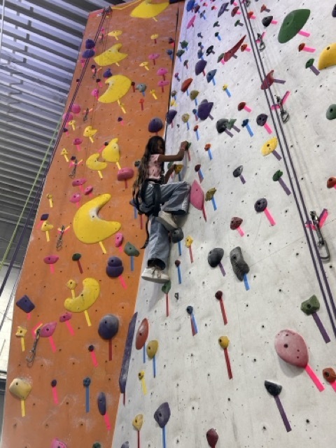 A fourth grader climbs a rock wall at the Philadelphia Rock Gym.