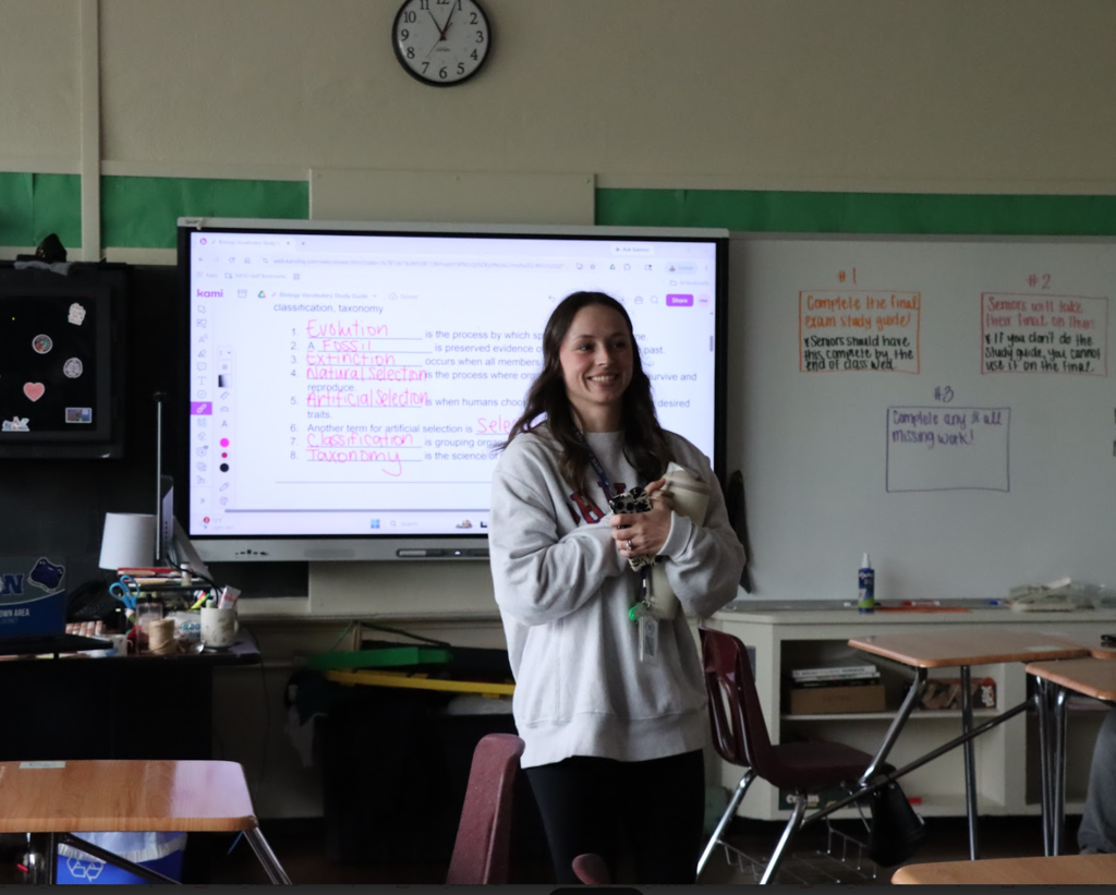 The teacher of the year winner is in the middle of her classroom. 