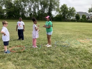 Students play Championship Rock, Paper, Scissors at Field Day.