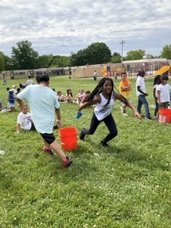 Students play a water relay game at Field Day.