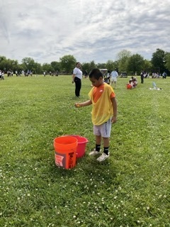 A student plays a water relay game at Field Day.