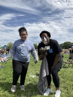 Dr. Harper poses with the student who gave her a pie in the face at field day.