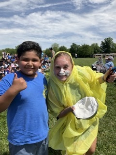 Ms. Capone poses with the student who gave her a pie in the face at field day.