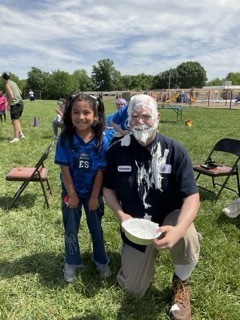 Mr. Donovan poses with the student who gave him a pie in the face at field day.