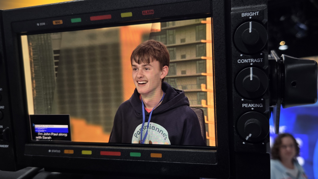 Student on news camera monitor.
