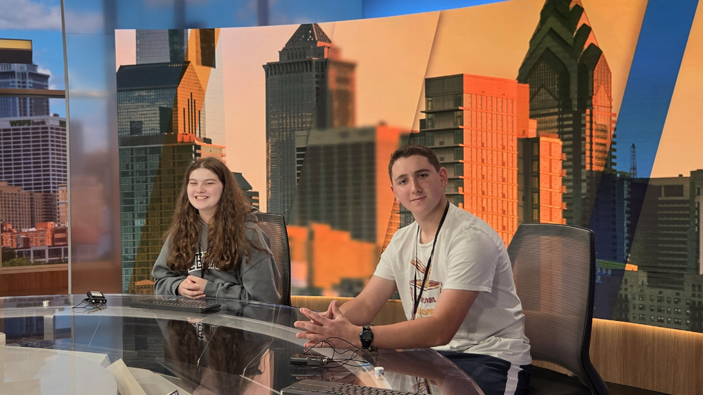 Two students sitting at the 6ABC news desk.