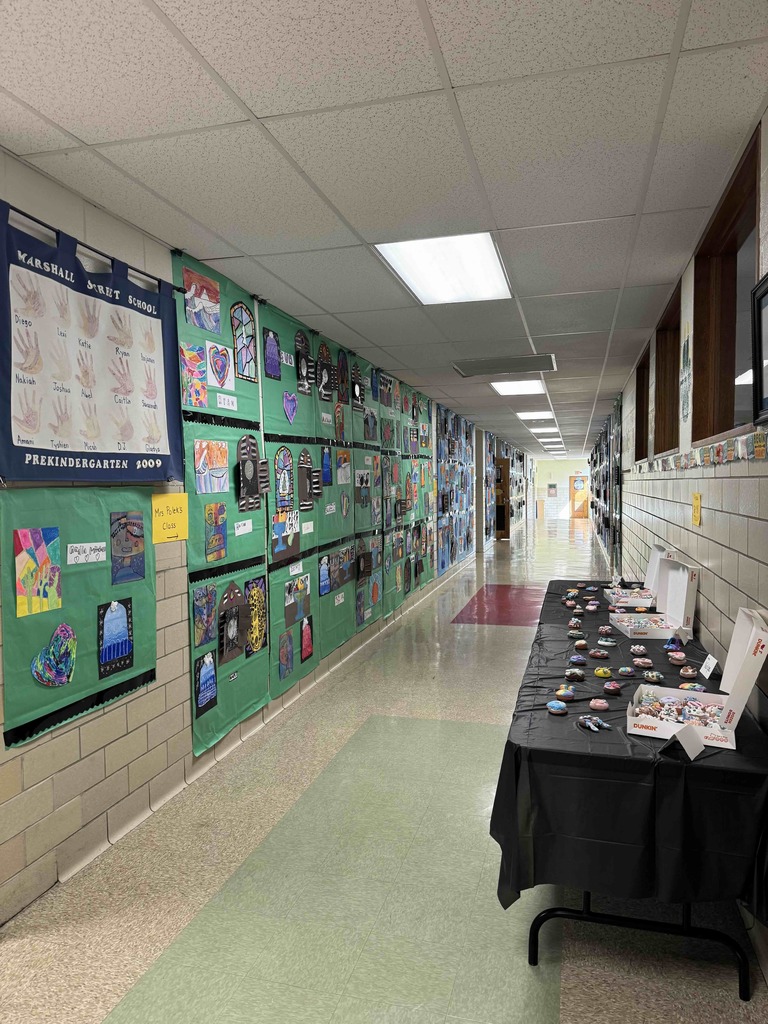 Student artwork displayed in the hallway for Marshall Street's annual Art Show.
