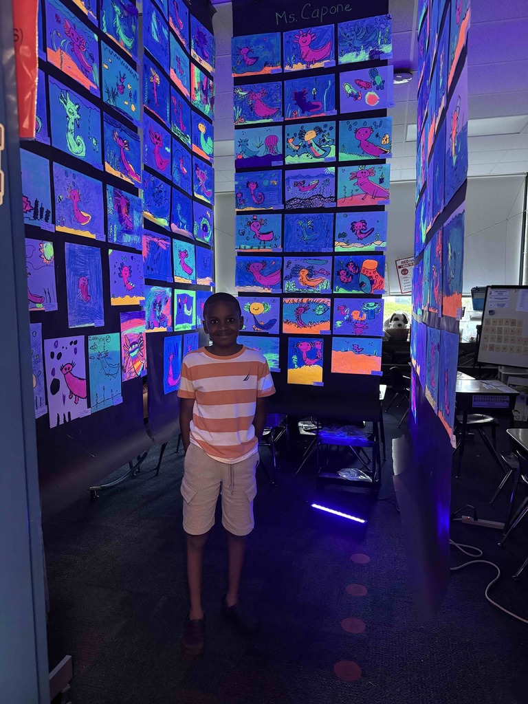 A student enjoys glow in the dark art at Marshall Street's annual Art Show.