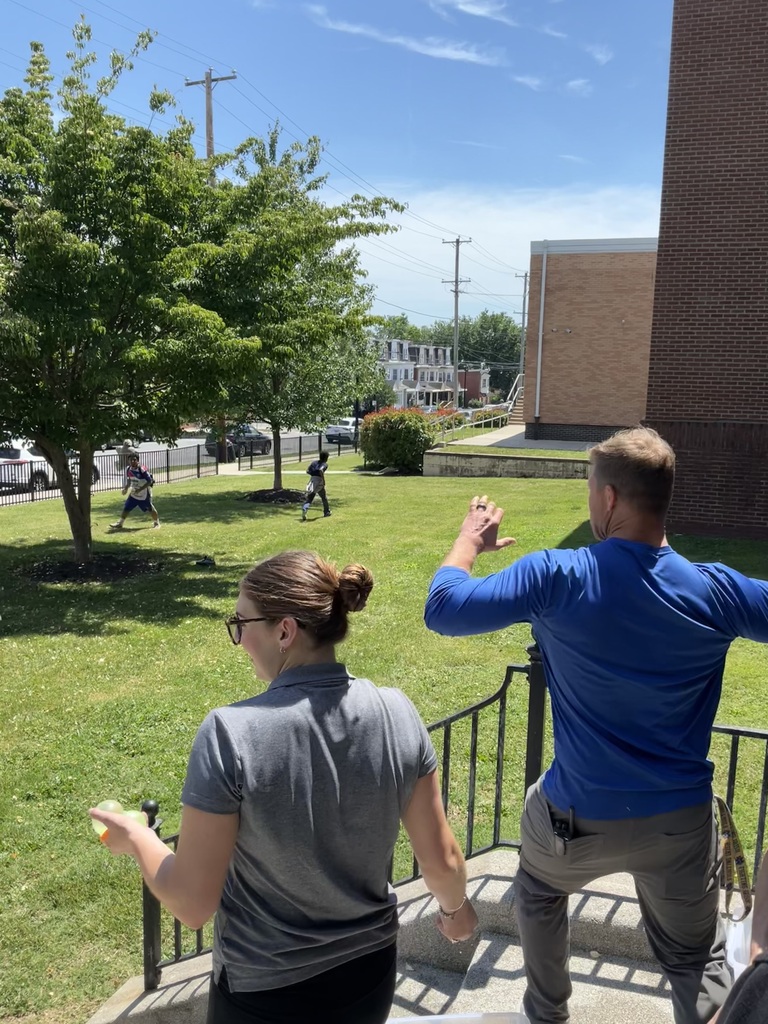 Two staff members are throwing water balloons