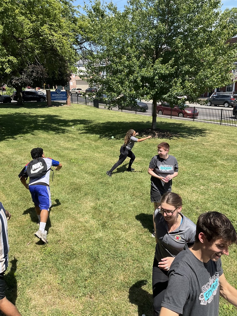 Students and staff are throwing water balloons on the front lawn
